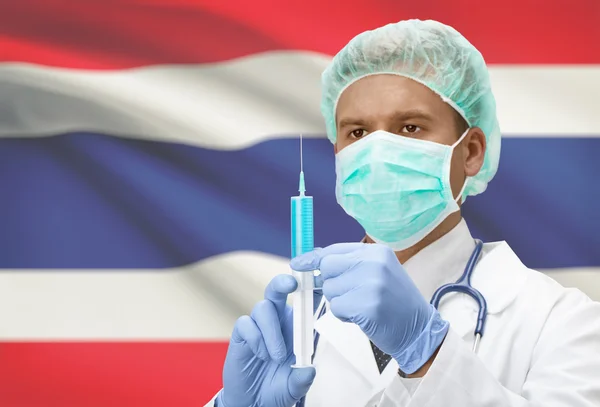 Доктор с шприц в руках и флаг на фоне серии - Таиланд — стоковое фото