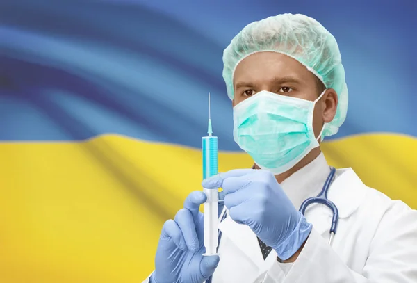 Läkare med spruta i händer och flagga på bakgrunden serien - Ukraina — Stockfoto