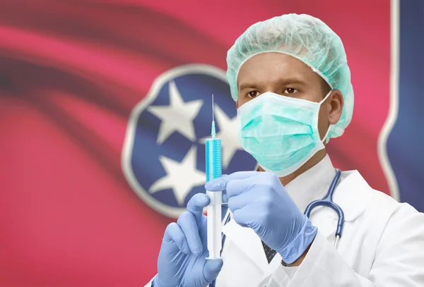 Docteur avec une seringue dans les mains et nous indique les drapeaux sur les séries de fond - Tennessee — Photo