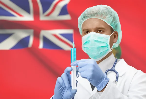 Médico con jeringa en las manos y la bandera de la provincia canadiense en serie de fondo - Manitoba —  Fotos de Stock