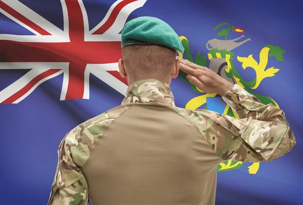 Dark-skinned soldier with flag on background - Pitcairn Island — Stock Photo, Image