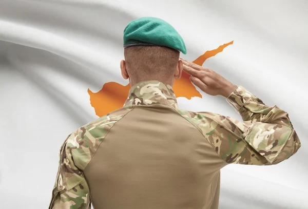 Dark-skinned soldier with flag on background - Cyprus — Stock Photo, Image
