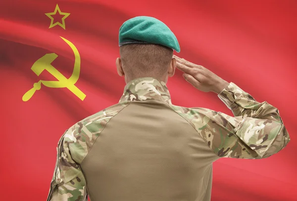 Dark-skinned soldier with flag on background - USSR - Soviet Union — Stock Photo, Image