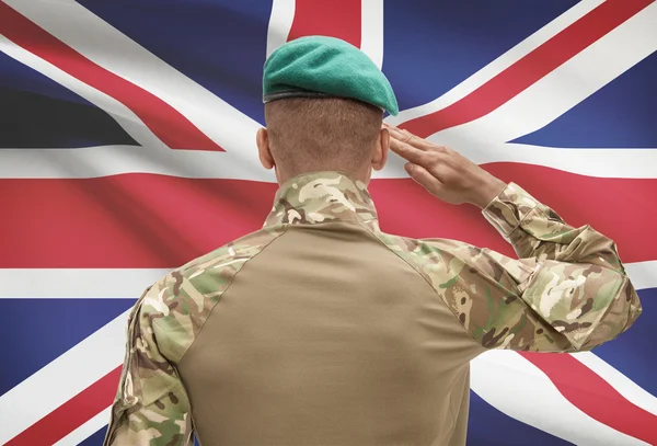 Dark-skinned soldier with flag on background - United Kingdom — Stock Photo, Image