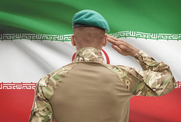 Sötét bőrű katona zászló a háttérben - Irán — Stock Fotó