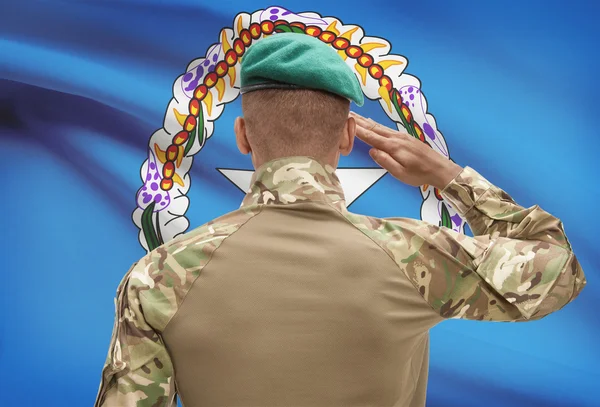 Dark-skinned soldier with flag on background - Northern Marianas — Stock Photo, Image