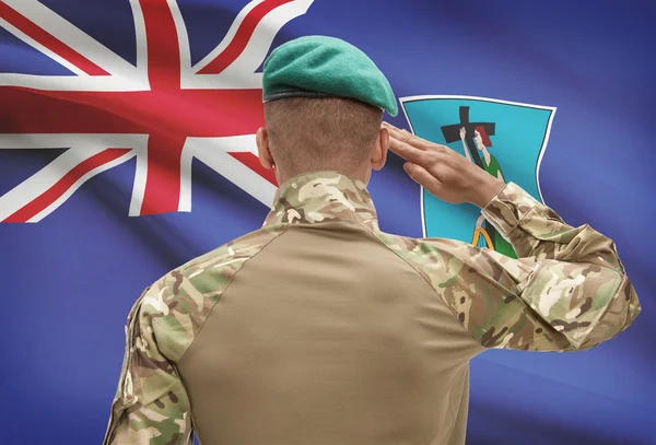 Dark-skinned soldier with flag on background - Montserrat — Stock Photo, Image