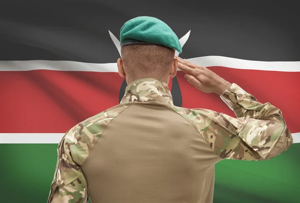 Dark-skinned soldier with flag on background - Kenya