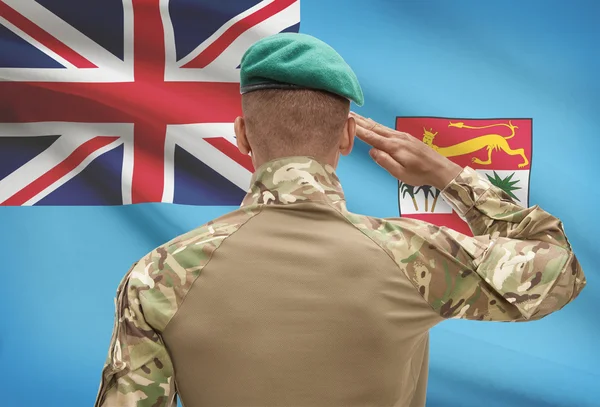 Dark-skinned soldier with flag on background - Fiji — Stock Photo, Image