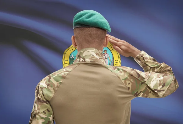 Dark-skinned soldier with US state flag on background - Idaho — Stock Photo, Image