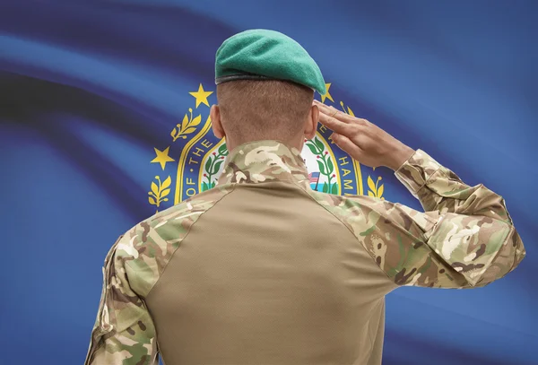 Dark-skinned soldier with US state flag on background - New Hampshire — Stock Photo, Image