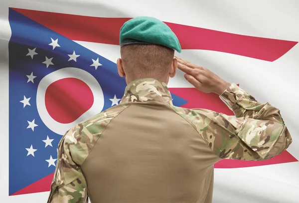 Dark-skinned soldier with US state flag on background - Ohio — Stock Photo, Image