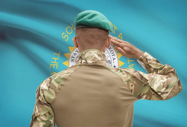 Dark-skinned soldier with US state flag on background - South Dakota — Stock Photo, Image