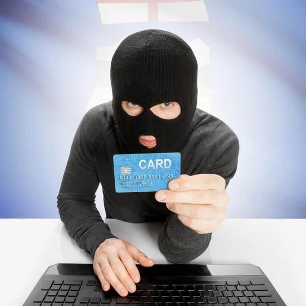 Hacker with credit card in hand and Canadian province flag - Alberta — Stock Photo, Image