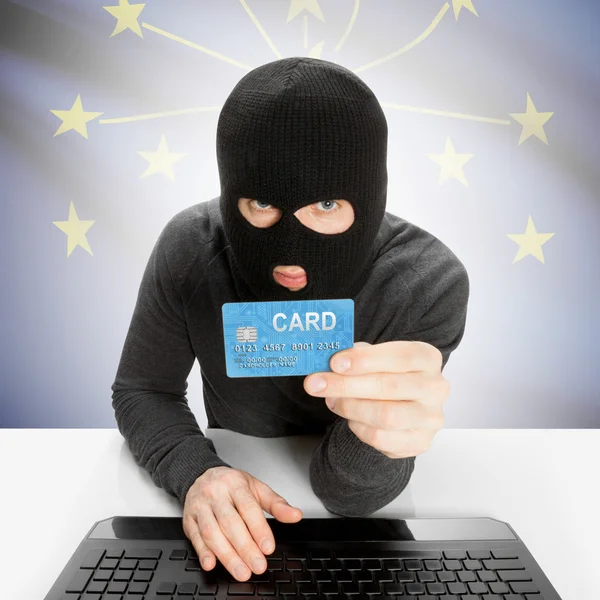 Hacker holding credit card with US state flag - Indiana — Stock Photo, Image