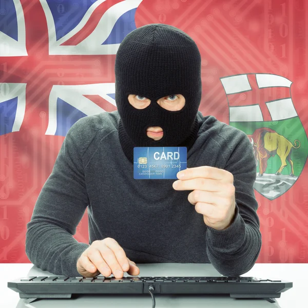 Hacker con tarjeta de crédito y la bandera de la provincia canadiense - Manitoba —  Fotos de Stock