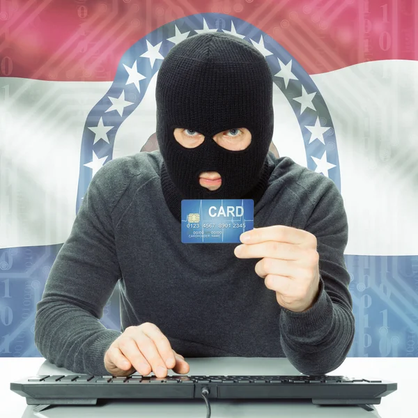Hacker holding credit card and USA state flag - Missouri — Stock Photo, Image