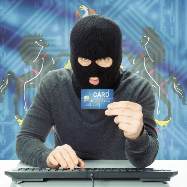 Hacker holding credit card and USA state flag - Pennsylvania — Stock Photo, Image