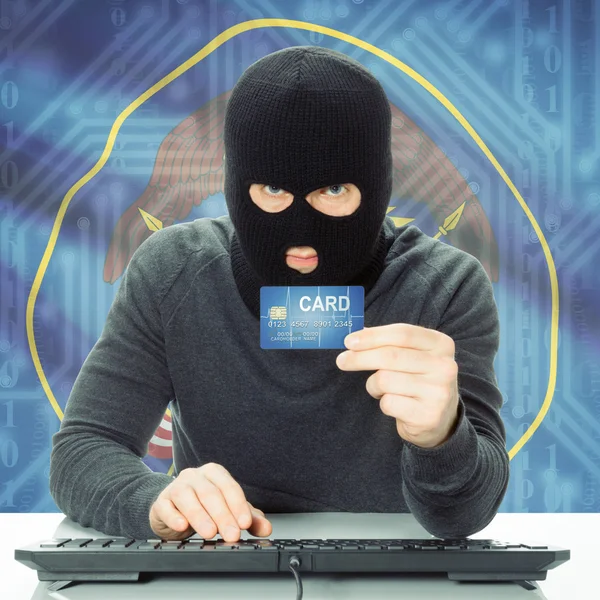 Hacker holding credit card and USA state flag - Utah — Stock Photo, Image