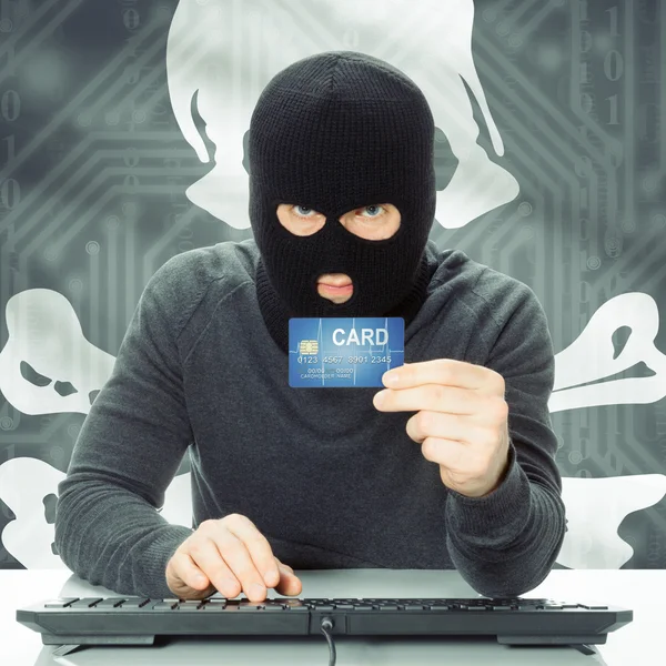 Hacker holding credit card and flag - Jolly Roger — Stock Photo, Image