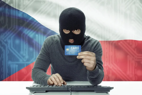 Dark-skinned hacker with flag on background holding credit card - Czech Republic — Stock Photo, Image