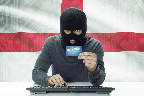 Dark-skinned hacker with flag on background holding credit card - England —  Fotos de Stock