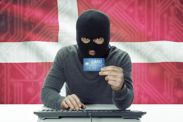 Dark-skinned hacker with flag on background holding credit card - Denmark — 图库照片