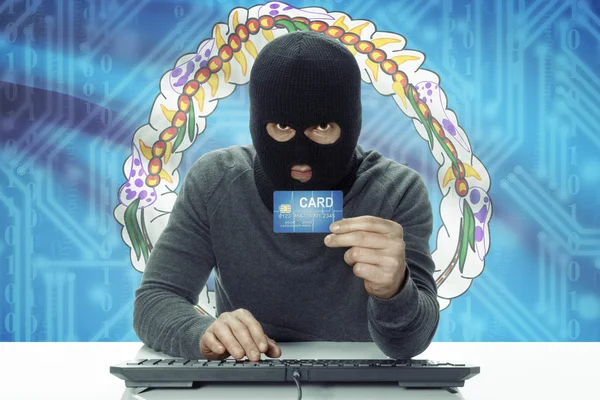 Dark-skinned hacker with flag on background holding credit card - Northern Marianas — 스톡 사진