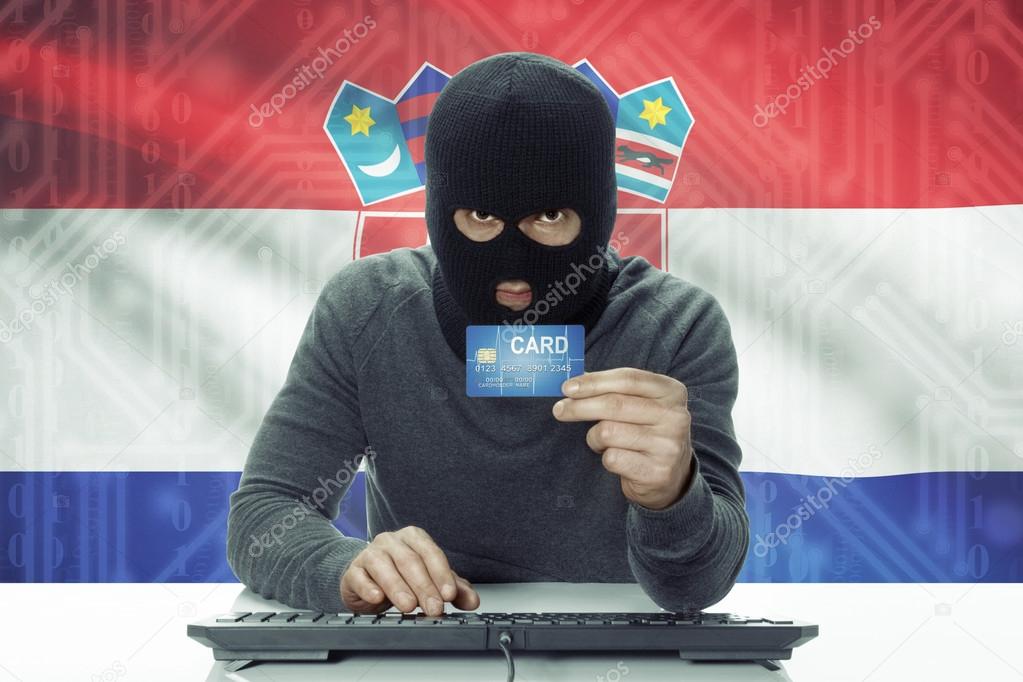Dark-skinned hacker with flag on background holding credit card - Croatia