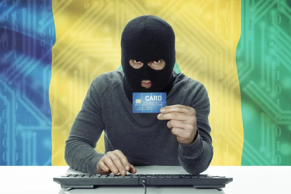 Dark-skinned hacker with flag on background holding credit card - Saint Vincent and the Grenadines — 图库照片