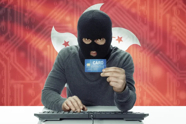 Dark-skinned hacker with flag on background holding credit card - Hong Kong — Foto de Stock