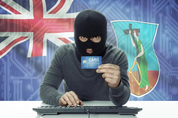 Dark-skinned hacker with flag on background holding credit card - Montserrat —  Fotos de Stock