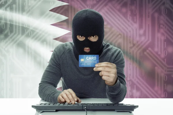 Dark-skinned hacker with flag on background holding credit card - Qatar — Stock Photo, Image