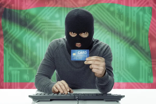 Dark-skinned hacker with flag on background holding credit card - Maldives — Foto de Stock