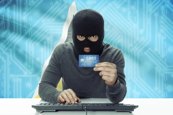 Dark-skinned hacker with flag on background holding credit card - Saint Lucia — Stock Photo, Image