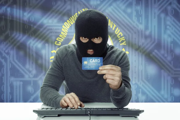 Dark-skinned hacker with USA states flag on background holding credit card - Kentucky —  Fotos de Stock