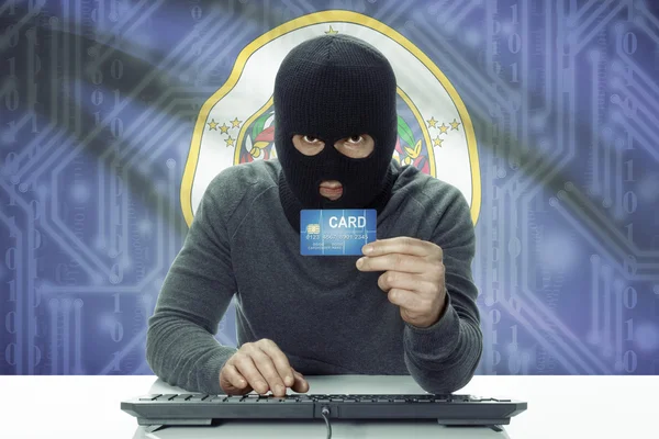 Dark-skinned hacker with USA states flag on background holding credit card - Minnesota — Stok fotoğraf