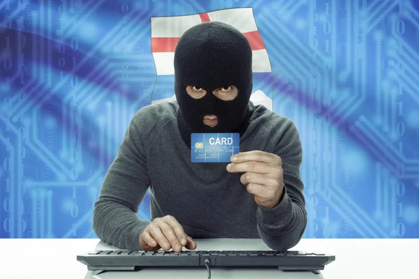 Dark-skinned hacker with Canadian province flag on background holding credit card - Alberta — 스톡 사진