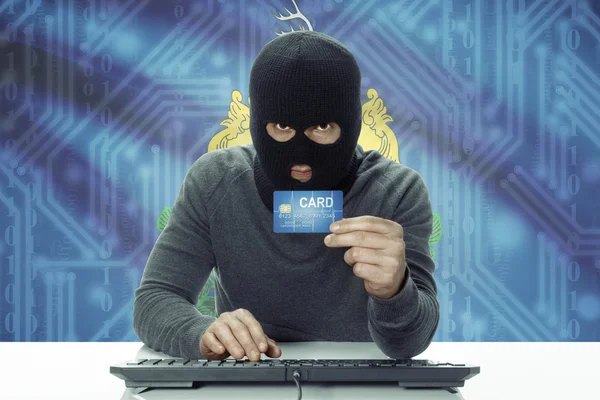 Dark-skinned hacker with USA states flag on background holding credit card - Vermont — Stok fotoğraf