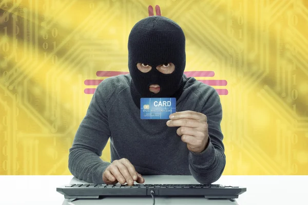 Dark-skinned hacker with USA states flag on background holding credit card - New Mexico — Stock Photo, Image