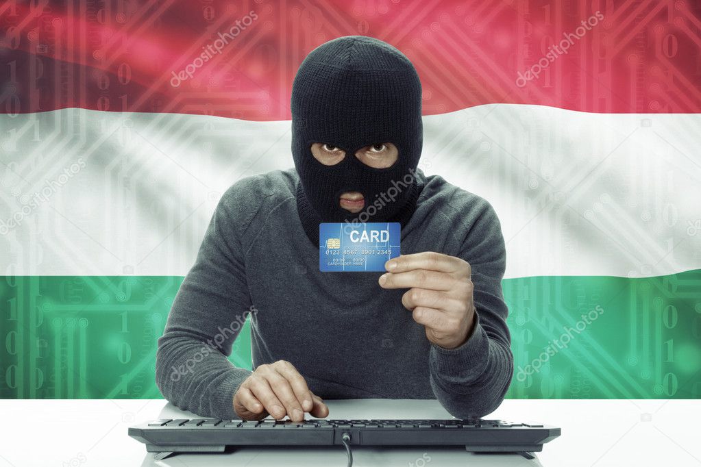 Dark-skinned hacker with flag on background holding credit card - Hungary