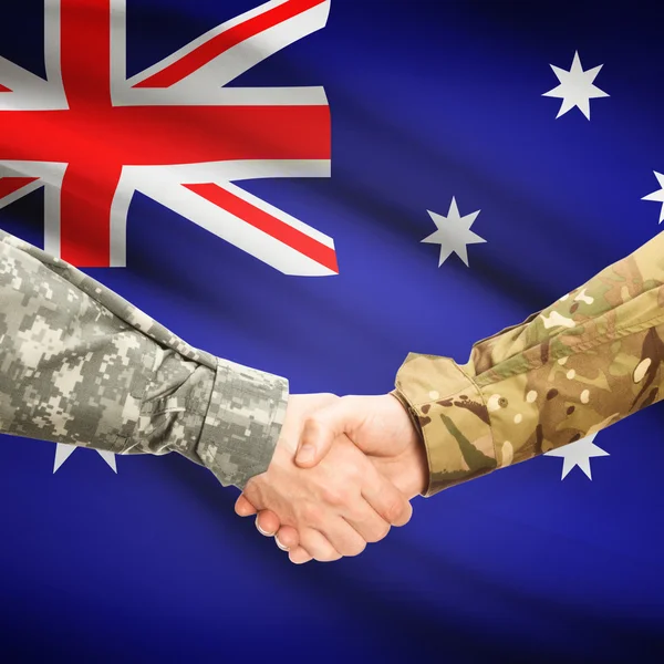 Hombres en uniforme de estrecharme la mano con la bandera en el fondo - Australia — Foto de Stock