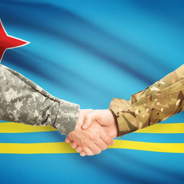 Men in uniform shaking hands with flag on background - Aruba — Stock Photo, Image