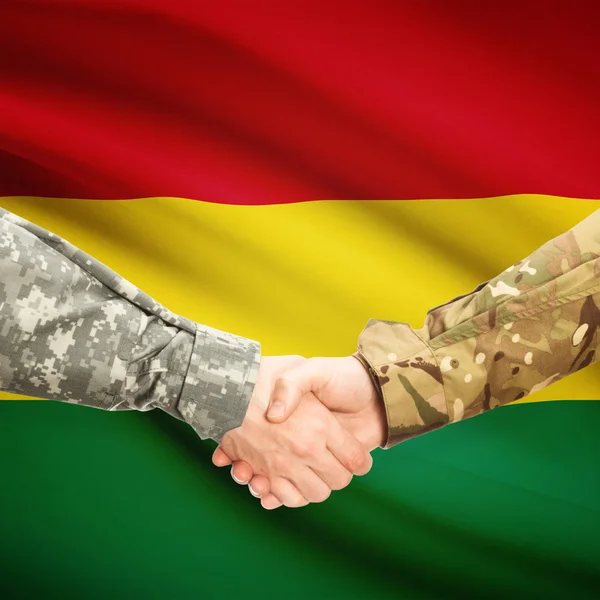 Hombres en uniforme de estrecharme la mano con la bandera en el fondo - Bolivia — Foto de Stock