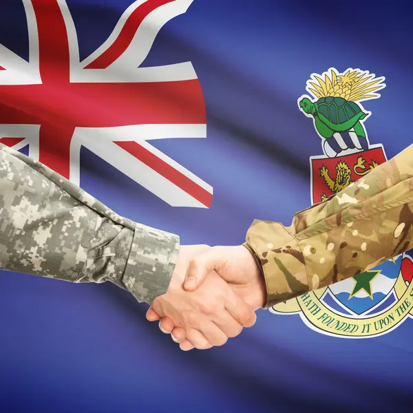 Men in uniform shaking hands with flag on background - Cayman Is — Stock Photo, Image