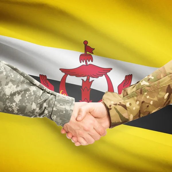 Men in uniform shaking hands with flag on background - Brunei — Stock Photo, Image