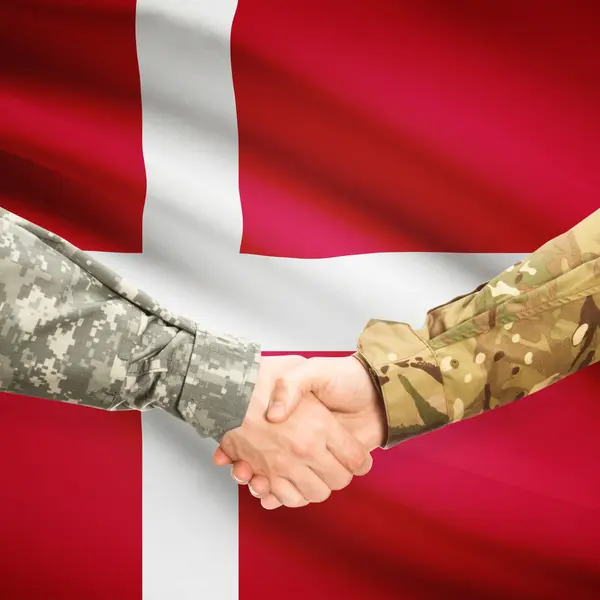 Men in uniform shaking hands with flag on background - Denmark — Stock Photo, Image