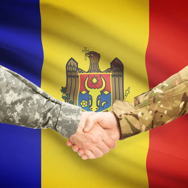 Men in uniform shaking hands with flag on background - Moldova — Stock Photo, Image