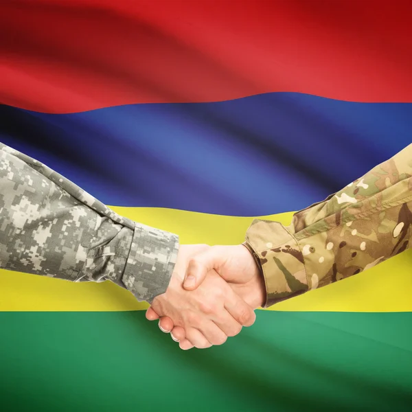 Men in uniform shaking hands with flag on background - Mauritius — Stock Photo, Image