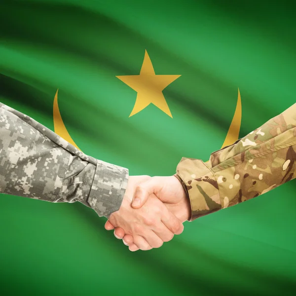 Men in uniform shaking hands with flag on background - Mauritani — Stock Photo, Image